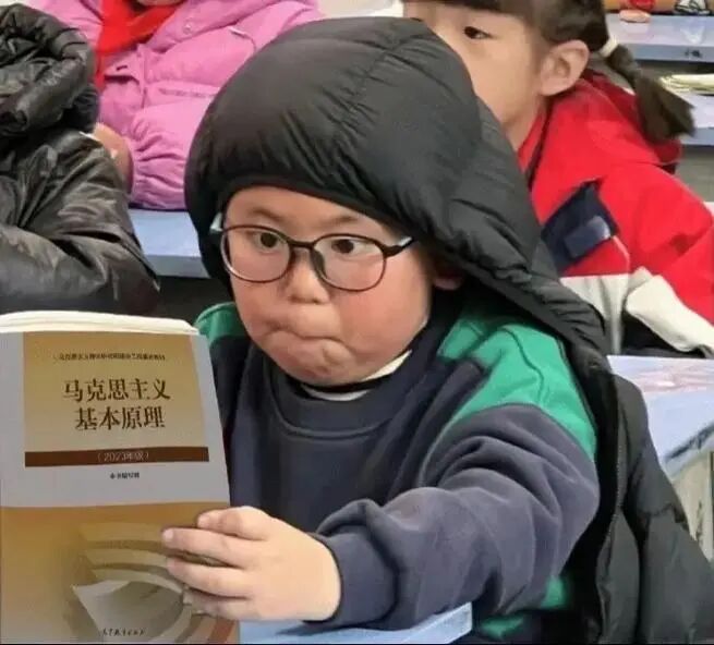 Child holding a textbook titled Basic Principles of Marxism